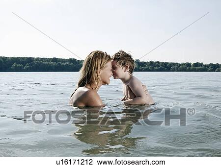Mother and child touch noses in river View Large Photo Image Stock Image - Mother and child touch noses in river. Fotosearch