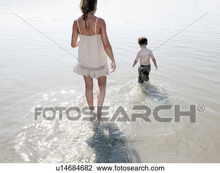 Mother and Child walking in river View Large Photo Image Stock Image - Mother and Child walking in river. Fotosearch
