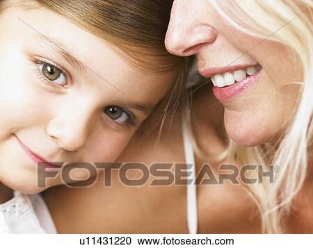 Mother and daughter cuddling View Large Photo Image Stock Image - Mother and daughter cuddling. Fotosearch