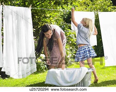 Mother and daughter doing the laundry View Large Photo Image Picture - Mother and daughter doing the laundry. Fotosearch