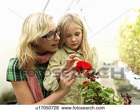 Mother and daughter in green house View Large Photo Image Stock Photo - Mother and daughter in green house. Fotosearch