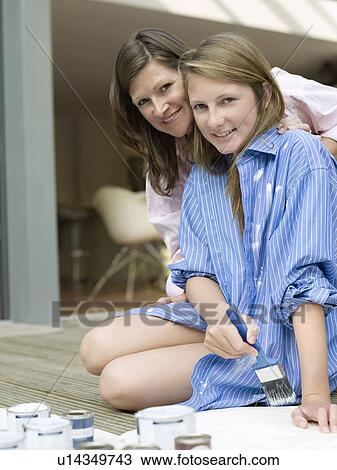 mother and daughter in painting clothes View Large Photo Image Stock Image - mother and daughter in painting clothes. Fotosearch