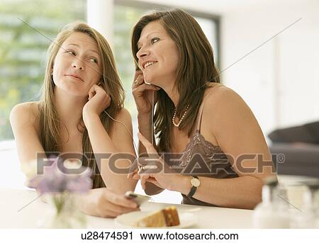 mother and daughter listen to mp3 player View Large Photo Image Stock Image - mother and daughter listen to mp3 player. Fotosearch