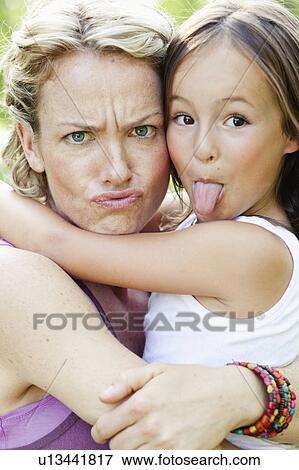 Stock Photo - mother and daughter making faces. Fotosearch