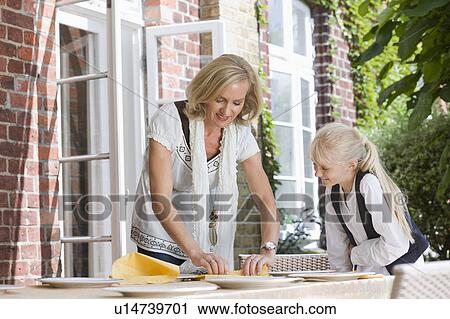 mother and daughter preparing table View Large Photo Image Stock Image - mother and daughter preparing table. Fotosearch