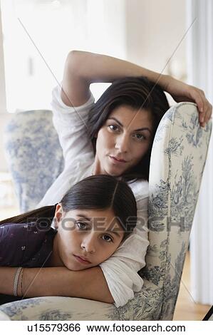 mother and daughter sitting in one chair View Large Photo Image Stock Photograph - mother and daughter sitting in one chair. Fotosearch