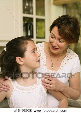 Mother and daughter smile at each other View Large Photo Image Stock Photo - Mother and daughter smile at each other. Fotosearch