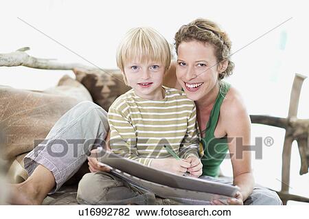 Stock Image - mother and son are painting. Fotosearch