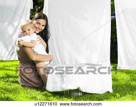 Mother and son cuddling in the laundry View Large Photo Image Stock Image - Mother and son cuddling in the laundry. Fotosearch