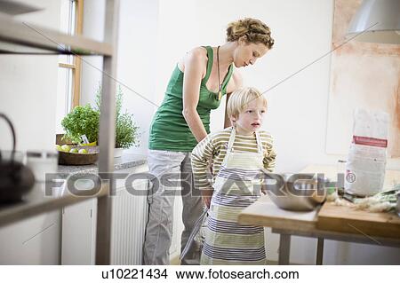 Picture - mother and son in kitchen. Fotosearch