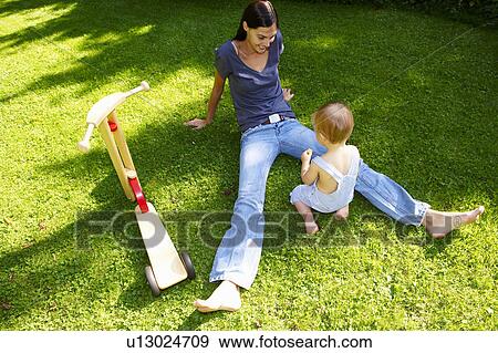 Stock Photo - Mother and son in the garden. Fotosearch