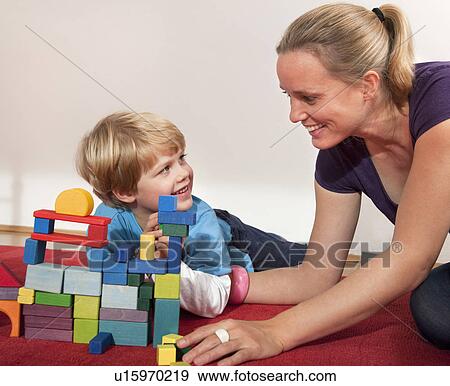 Stock Photo - mother and son play with building blocks. Fotosearch