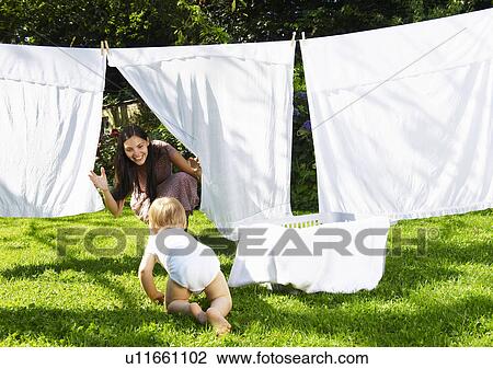 Mother and son playing in the laundry View Large Photo Image Stock Image - Mother and son playing in the laundry. Fotosearch