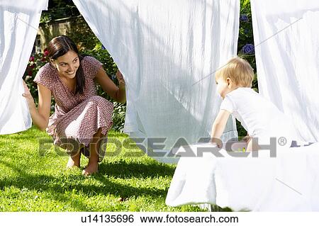 Mother and son playing in the laundry View Large Photo Image Stock Photograph - Mother and son playing in the laundry. Fotosearch