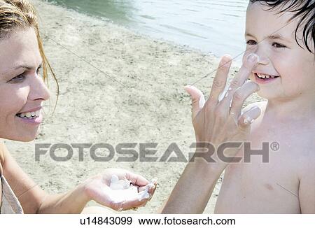 Mother applying sun lotion on Child View Large Photo Image Stock Photo - Mother applying sun lotion on Child. Fotosearch