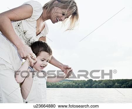Mother helping child View Large Photo Image Stock Image - Mother helping child. Fotosearch