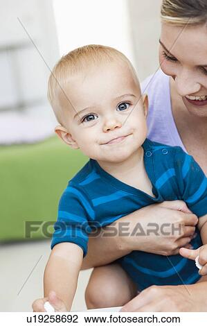 Stock Image - mother holding baby. Fotosearch