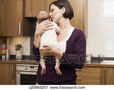 Mother holding her baby View Large Photo Image Stock Photo - Mother holding her baby. Fotosearch