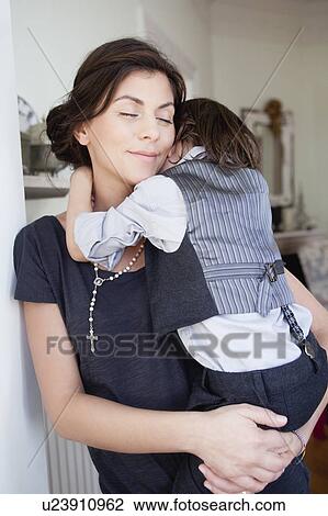 Stock Image - mother holding son in her arms. Fotosearch