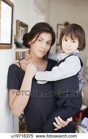 Stock Photography - mother holding son in her arms. Fotosearch