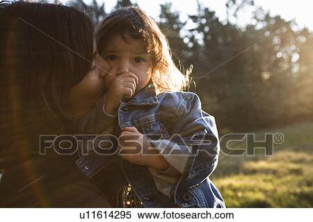 Stock Photography - Mother hugging daughter. Fotosearch