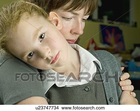 Picture - Mother hugging her daughter. Fotosearch
