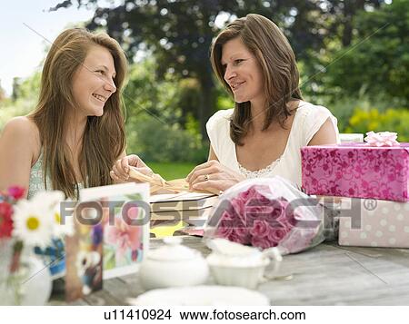 mother opening present from daughter View Large Photo Image Picture - mother opening present from daughter. Fotosearch
