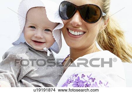 Picture - Mother with her baby girl, smiling. Fotosearch