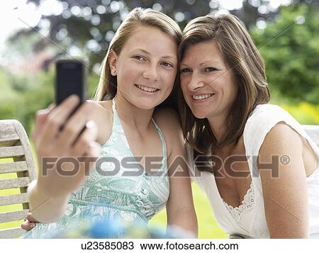 Stock Image - mum and daughter pose for self-portrait. Fotosearch