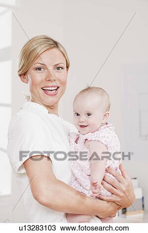 Nurse holding a baby View Large Photo Image Stock Image - Nurse holding a baby. Fotosearch