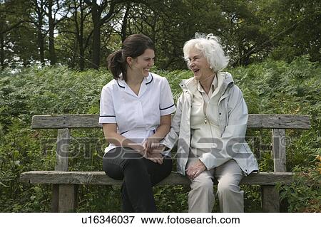 Stock Photo - Nurse holding hand of elderly woman. Fotosearch