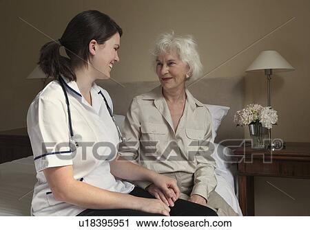 Nurse holding the hand of elderly woman View Large Photo Image Stock Image - Nurse holding the hand of elderly woman. Fotosearch