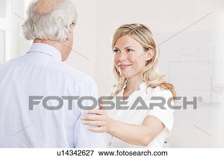 Stock Photo - Old man and woman in a white lab coat. Fotosearch