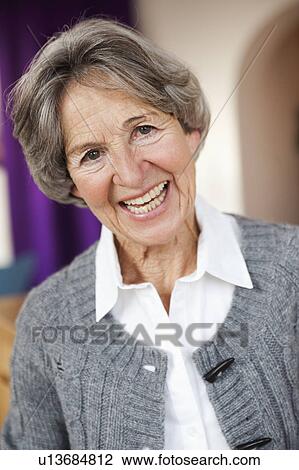 Stock Image - old woman smiling at viewer. Fotosearch