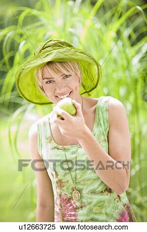 outdoor portrait of a woman with apple View Large Photo Image Stock Photography - outdoor portrait of a woman with apple. Fotosearch