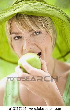 outdoor portrait of a woman with apple View Large Photo Image Stock Photography - outdoor portrait of a woman with apple. Fotosearch