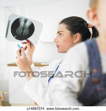 Picture - Pediatrician examining X-ray. Fotosearch