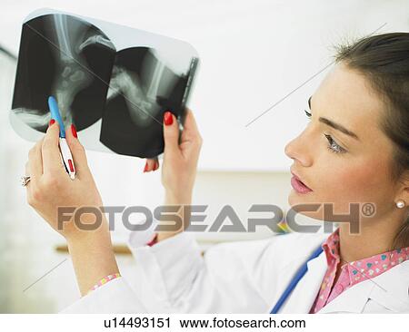 Stock Image - Pediatrician examining X-ray. Fotosearch