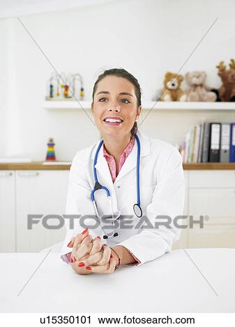 Stock Image - Pediatrician in her surgery. Fotosearch