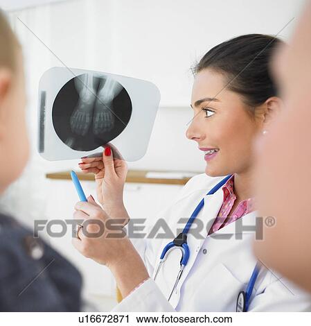 Pediatrician showing X-ray View Large Photo Image Stock Image - Pediatrician showing X-ray. Fotosearch