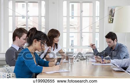People working at a a conference table View Large Photo Image Stock Photography - People working at a a conference table. Fotosearch
