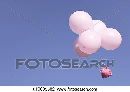 Stock Image - Piggy Bank flying with balloons. Fotosearch