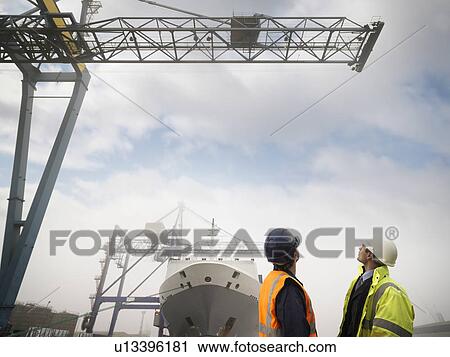 Stock Image - Port Worker And Businessman With Ship. Fotosearch