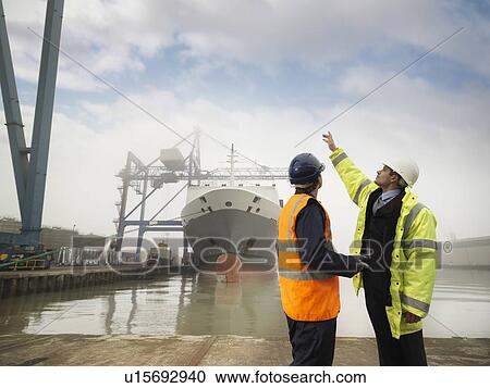 Stock Image - Port Worker And Businessman With Ship. Fotosearch