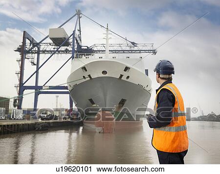 Port Worker Looking At Container Ship View Large Photo Image Stock Image - Port Worker Looking At Container Ship. Fotosearch