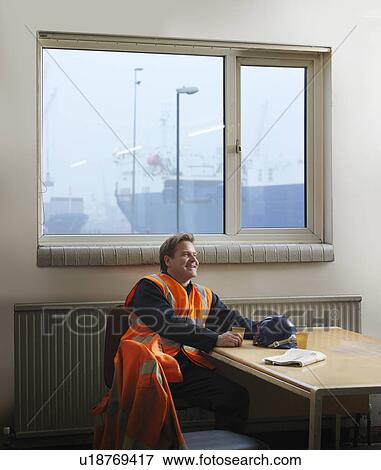 Stock Photo - Port Worker Relaxing With Hot Drink. Fotosearch