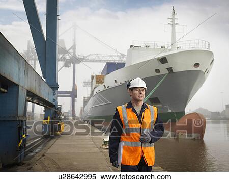 Stock Photography - Port Worker With Container Ship. Fotosearch