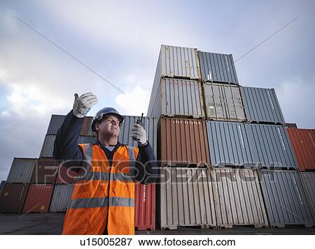 Stock Photo - Port Worker With Shipping Containers. Fotosearch