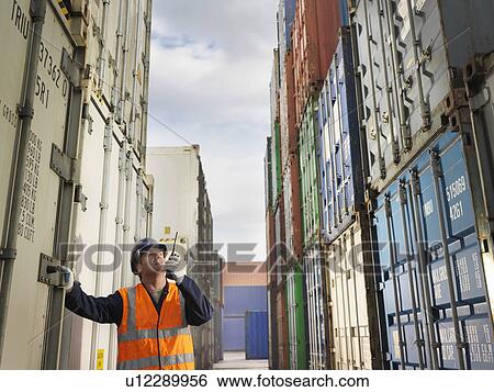 Stock Photograph - Port Worker With Shipping Containers. Fotosearch
