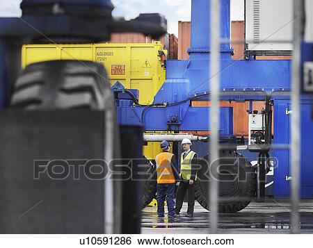 Port Workers With Heavy Machinery View Large Photo Image Stock Photograph - Port Workers With Heavy Machinery. Fotosearch